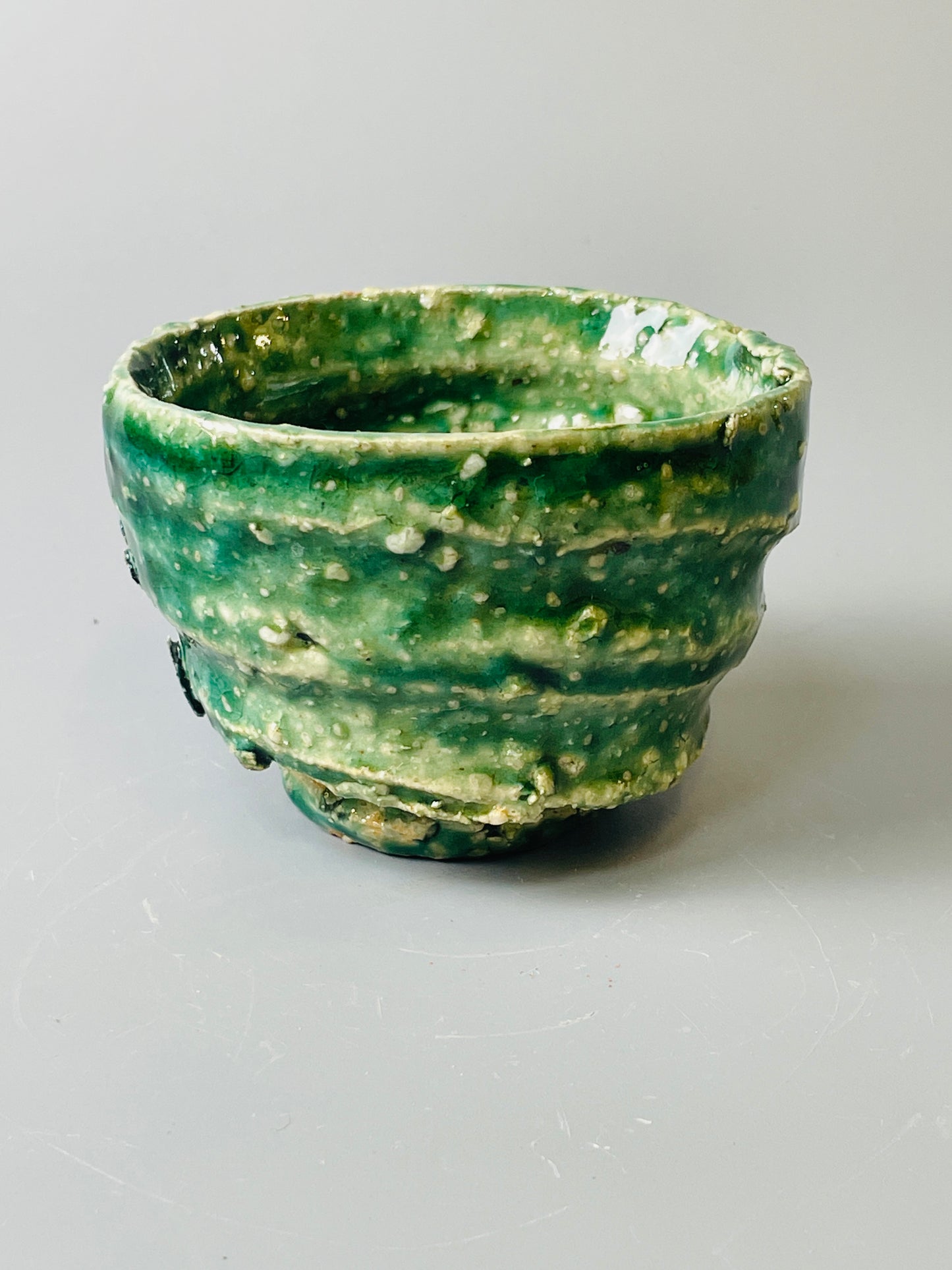 Shiga Oribe guinomi/espresso, side fired, inclusion body, needle ash, personal marks for AA, A145
