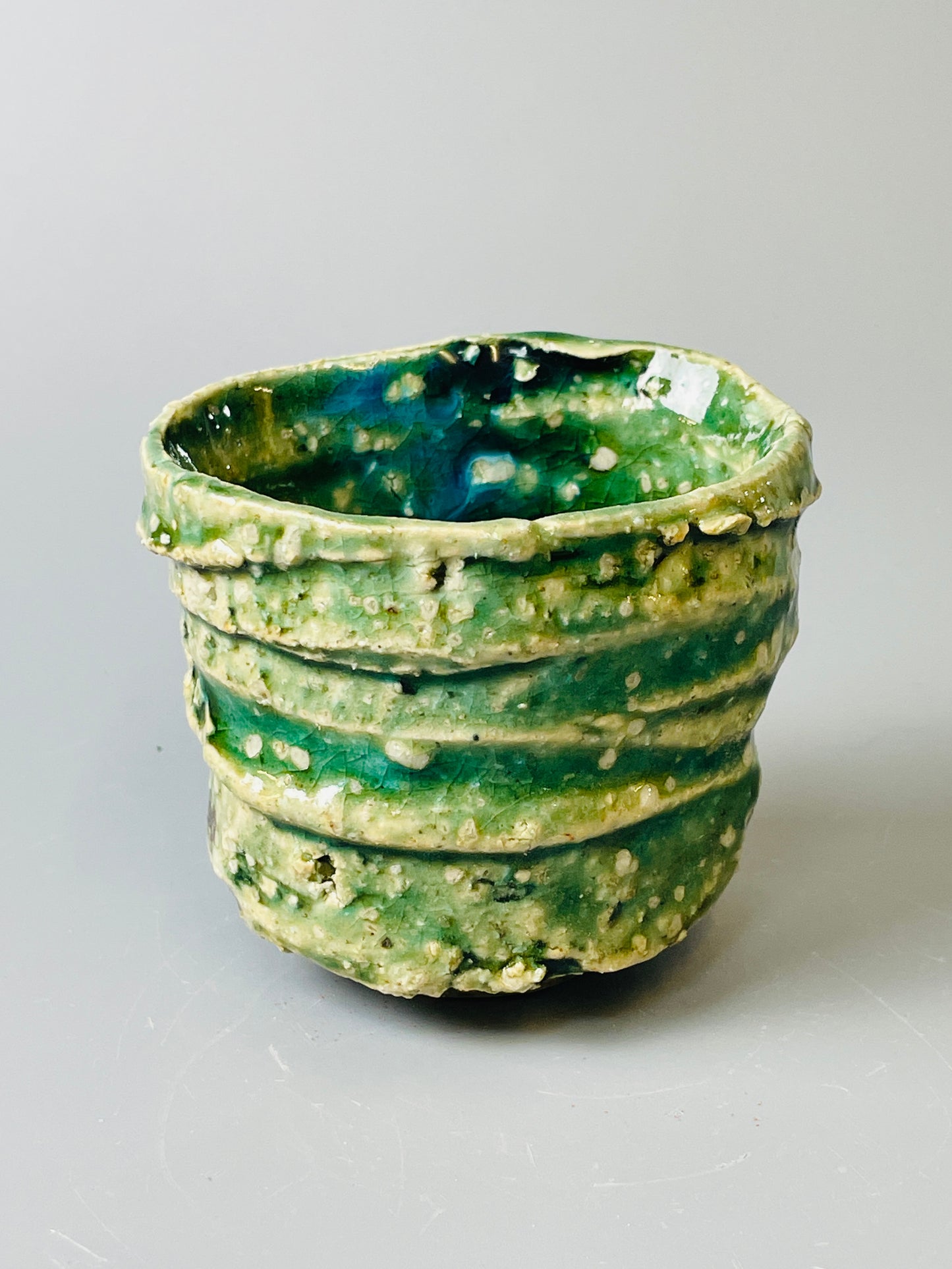 Shiga Oribe guinomi/espresso, side fired, inclusion body, needle ash, personal marks for AA, A146
